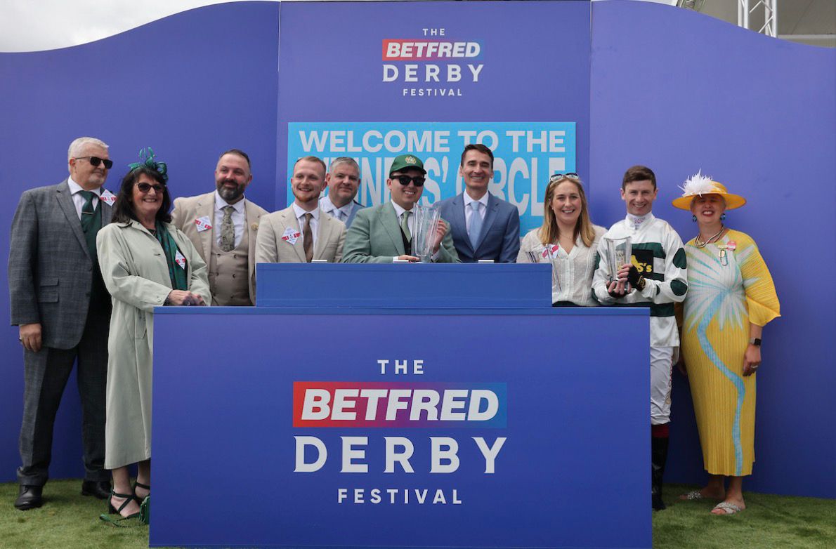 Collecting the trophy on the podium at Epsom
