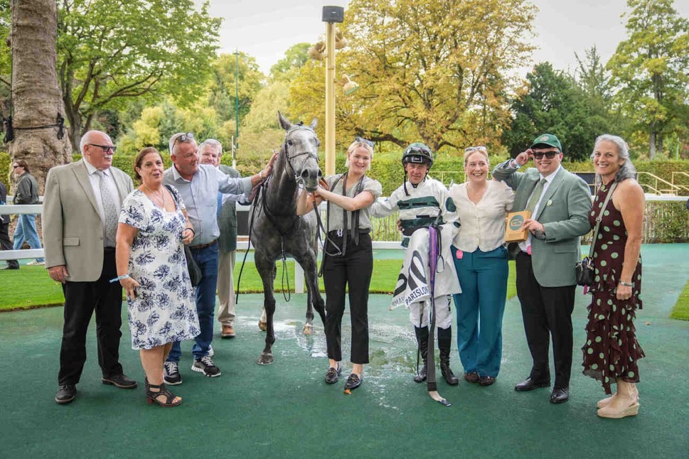 Members and connections with Naana's Shadow in the winners' enclosure at ParisLongchamp
